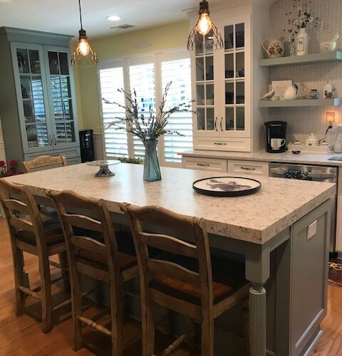 Warm Kitchen with Quartz Island, White Cabinets & Vintage Pendants