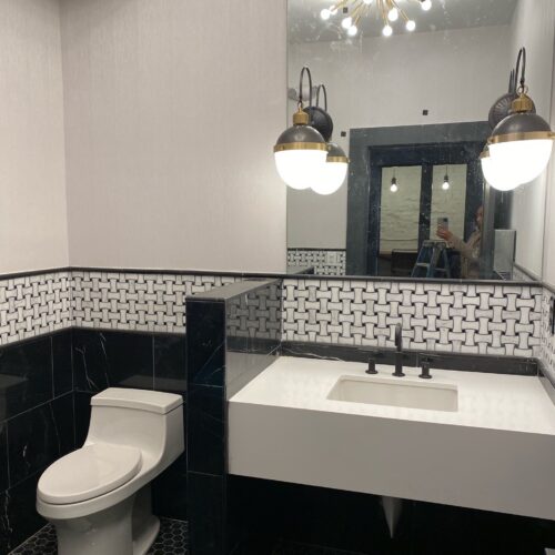 Modern Bathroom with Black & White Tile, Vanity & Chic Pendants