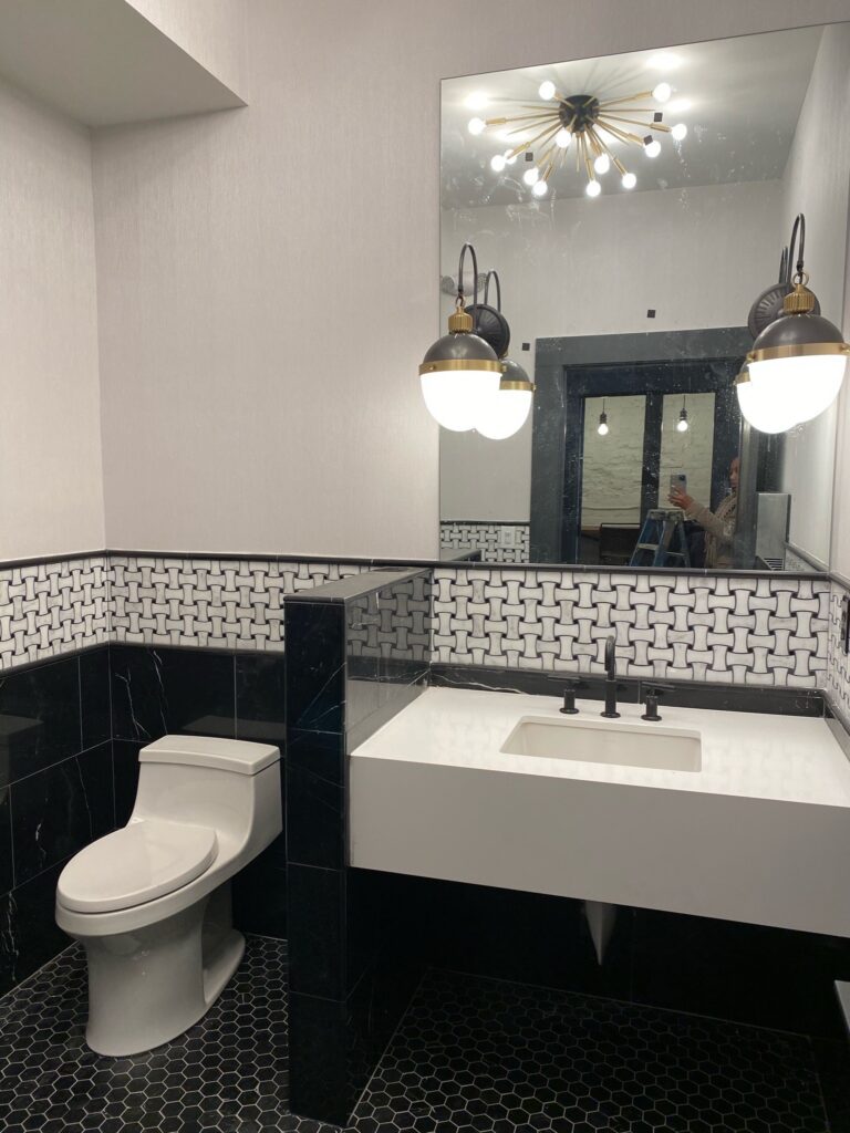 Modern Bathroom with Black & White Tile, Vanity & Chic Pendants
